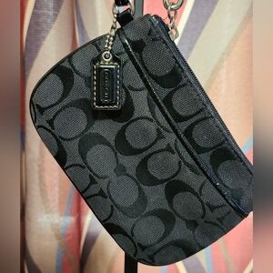 Coach Signature C black canvas wristlet with black leather trim.